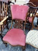 A VICTORIAN ROSEWOOD NURSING CHAIR WITH THE BUTTONED PINK VELVET TOP RAIL OVER A PIERCED AND