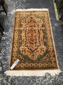 A MACHINE MADE PERSIAN DESIGN RUG. 169 x 92cms