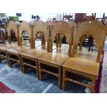 A SET OF TEN 20th C. OAK CHAIRS WITH ROUND ARCHED BACKS ABOVE SOLID SEATS AND LEGS JOINED BY