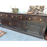 A 19th C. OAK DRESSER, THE THREE DRAWERS OVER TWO DOORS FLANKING A CENTRAL PANEL ABOVE THE PLINTH