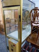 AN AYNHOE PARK GLAZED CABINET, THE INTERIOR WITH ELECTRONIC GRAB ARM.