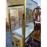 AN AYNHOE PARK GLAZED CABINET, THE INTERIOR WITH ELECTRONIC GRAB ARM.