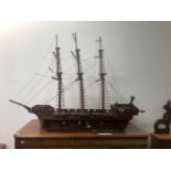 A NAIVE SCRATCH BUILT MODEL OF A LARGE SAILING SHIP.