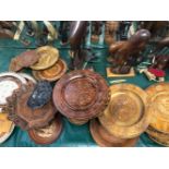 A LARGE QTY OF CARVED AND INLAID PLATES AND DISHES , CARVED FIGURES ETC