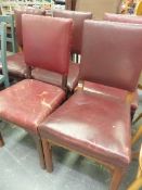 A SET OF FIVE LATE VICTORIAN OAK DINING CHAIRS WITH RED LEATHER UPHOLSTERED RECTANGULAR BACKS AND SE