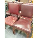 A SET OF FIVE LATE VICTORIAN OAK DINING CHAIRS WITH RED LEATHER UPHOLSTERED RECTANGULAR BACKS AND SE