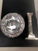A HALLMARKED SILVER CORINTHIAN COLUMN CANDLESTICK AND AN EASTERN WHITE METAL SMALL FOOTED SALVER.