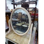 A PINK PAINTED OVAL DRESSING TABLE MIRROR, THE FRAME ROPE CARVED