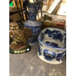 A LARGE BLUE AND WHITE FOOT BATH, A GERMAN STONEWARE EWER, AND A CAST IRON DOORSTOP.