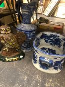 A LARGE BLUE AND WHITE FOOT BATH, A GERMAN STONEWARE EWER, AND A CAST IRON DOORSTOP.