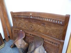 AN EASTERN VINE CARVED HARDWOOD DOUBLE BED. W 175, THE SIDE PANELS 200cms.