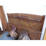 AN EASTERN VINE CARVED HARDWOOD DOUBLE BED. W 175, THE SIDE PANELS 200cms.