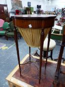 AN EDWARDIAN CROSS BANDED MAHOGANY WORK TABLE, THE CIRCULAR LID EXTENDED TO ROUNDELS OVER THE TOPS O