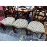 A SET OF THREE LATE VICTORIAN MAHOGANY SHIELD BACKED CHAIRS, THE FOUR BAR BACK SPLATS CENTRED BY