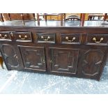 A 19th C. OAK DRESSER WITH THREE DRAWERS OVER TWO CRUCIFORM PANELLED DOORS CENTRAL TO FIGURE OF
