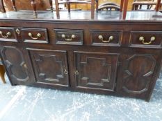 A 19th C. OAK DRESSER WITH THREE DRAWERS OVER TWO CRUCIFORM PANELLED DOORS CENTRAL TO FIGURE OF