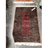 AN ORIENTAL RUG OF BOKHARA DESIGN. 131 x 79cms. TOGETHER WITH A MACHINE MADE RUG OF SIMILAR