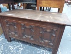 A 20th C. OAK COFFER WITH FOUR PANELLED FRONT. W 91 x D 45 x H 72cms.