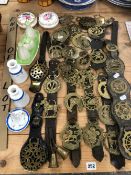 A QUANTITY OF ANTIQUE AND LATER HORSE BRASSES ON STRAPS.