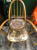 AN ERCOL STICK BACK ROCKING CHAIR TOGETHER WITH AN AFRICAN STOOL, THE SEAT WITH BEADED GIRAFFE AND