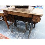 AN OAK AND IRON SINGER SEWING MACHINE TABLE WITH TWO DRAWERS AND THE SEWING MACHINE