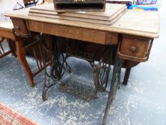 AN OAK AND IRON SINGER SEWING MACHINE TABLE WITH TWO DRAWERS AND THE SEWING MACHINE