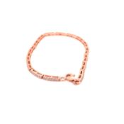 A SILVER AND ROSE GOLD GILT CUBIC ZIRCONIA LINE BRACELET. LENGTH 18.5cms. WEIGHT 5.75grms.