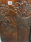 A MAHOGANY STAINED PINE WALL CUPBOARD, THE DOOR CARVED IN THE RUSSIAN STYLE WITH A BIRD PERCHED