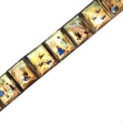 A PERSIAN MOTHER OF PEARL HAND PAINTED EIGHT PANEL BRACELET. THE REVERSE WITH MIDDLE EASTERN