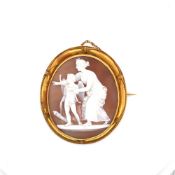 AN ANTIQUE HELMET SHELL CAMEO BROOCH DEPICTING A RARE SUBJECT OF VENUS TEACHING CUPID TO USE HIS