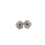 A PAIR OF EMERALD AND DIAMOND CLUSTER EARRINGS. THE EMERALD CENTRE SURROUNDED BY A CLUSTER OF SIX