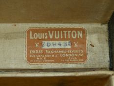 A LOUIS VUITTON BLACK SUITCASE, THE INTERIOR WITH STRAP TIES TO HOLD FOLDED CLOTHES IN PLACE.