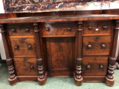 A VICTORIAN MAHOGANY KNEEHOLE WRITING TABLE/ SIDE CABINET, THE THREE QUARTER GALLERIED TOP OVER A