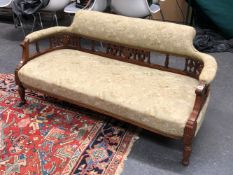 AN EDWARDIAN MAHOGANY SETTEE, THE TOP RAIL AND ARM RESTS UPHOLSTERED ABOVE A BACK RAIL OF SWAGS