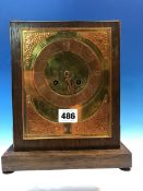 AN ARTS AND CRAFTS MANTLE CLOCK STRIKING ON A BELL, THE BRASS DIAL WITH COPPER CHAPTER RING AND