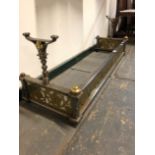 A 19th C. IRON FIRE KERB WITH FIRE IRON RESTS AND BRASS BOSSES RAISED ABOVE THE PIERCED FLORAL