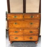 A VICTORIAN BRASS BOUND TEAK CAMPAIGN CHEST IN TWO HALVES WITH TWO SHORT AND THREE LONG DRAWERS ON