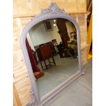 A VICTORIAN STYLE ROUND ARCHED MIRROR IN A BEADED GREY PAINTED FRAME TOPPED BY A TREFOIL FLANKED