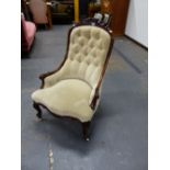 A VICTORIAN BEIGE VELVET UPHOLSTERED ROSEWOOD NURSING CHAIR, THE PAIR OF FLOWERS ON THE TOP RAIL