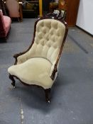 A VICTORIAN BEIGE VELVET UPHOLSTERED ROSEWOOD NURSING CHAIR, THE PAIR OF FLOWERS ON THE TOP RAIL