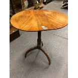A GEORGE III MAHOGANY TRIPOD TABLE, THE OVAL TOP ON A GUN BARREL COLUMN AND ARCHED LEGS. W 59 x D 47