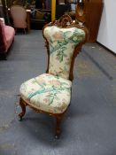 A VICTORIAN MAHOGANY SHOW FRAME NURSING CHAIR, THE SHELL CENTRED TOP RAIL WITH FRUIT AND FOLIAGE