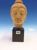 A COMPOSITION STONE HEAD OF THE BUDDHA IN SUKHOTHAI STYLE AND MOUNTED ON A SQUARE BLACK BASE. H