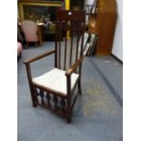 AN ART NOUVEAU MAHOGANY ELBOW CHAIR, THE TOP RAIL INLAID WITH HEARTS ABOVE FOUR PEACOCK EYE TOPPED