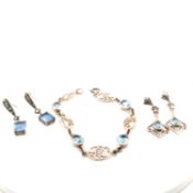 A BLUE TOPAZ FOLIATE PANEL BRACELET TOGETHER WITH A PAIR OF BLUE TOPAZ EARRINGS AND A FURTHER PAIR