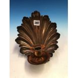 A COPPER WALL SCONCE, THE CANDLE NOZZLE AND DRIP PAN MOUNTED AGAINST A SHELL SHAPE BACK PLATE. H