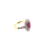 A VINTAGE RUBY AND DIAMOND CLUSTER RING. THE OVAL RUBY APPROX 8 X 6.2 X DEPTH 4.0mm. FINGER SIZE