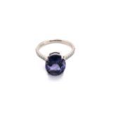 A PLATINUM HALLMARKED AMETHYST AND DIAMOND RING. THE OVAL CUT AMETHYST IN A RAISED FOUR CLAW