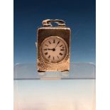 A HALLMARKED SILVER CASED SMALL DRESSING TABLE CLOCK WITH HAMMERED FINISH (PROBABLY BIRMINGHAM