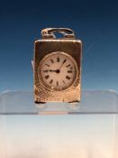 A HALLMARKED SILVER CASED SMALL DRESSING TABLE CLOCK WITH HAMMERED FINISH (PROBABLY BIRMINGHAM